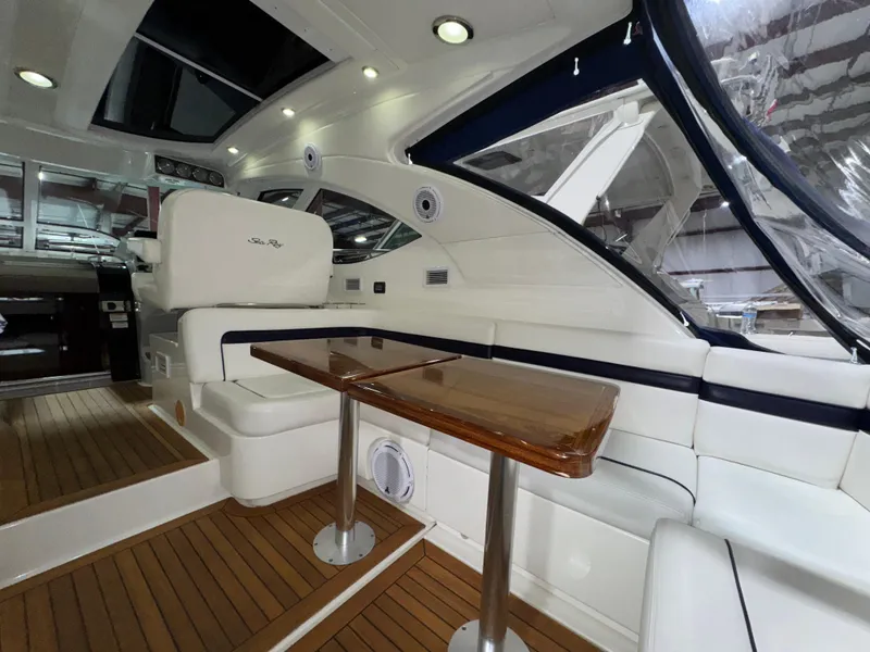 Slide: The Image of Luxurious interior of 2011 Sea Ray 470 Sundancer yacht with elegant seating and wooden table. - 42