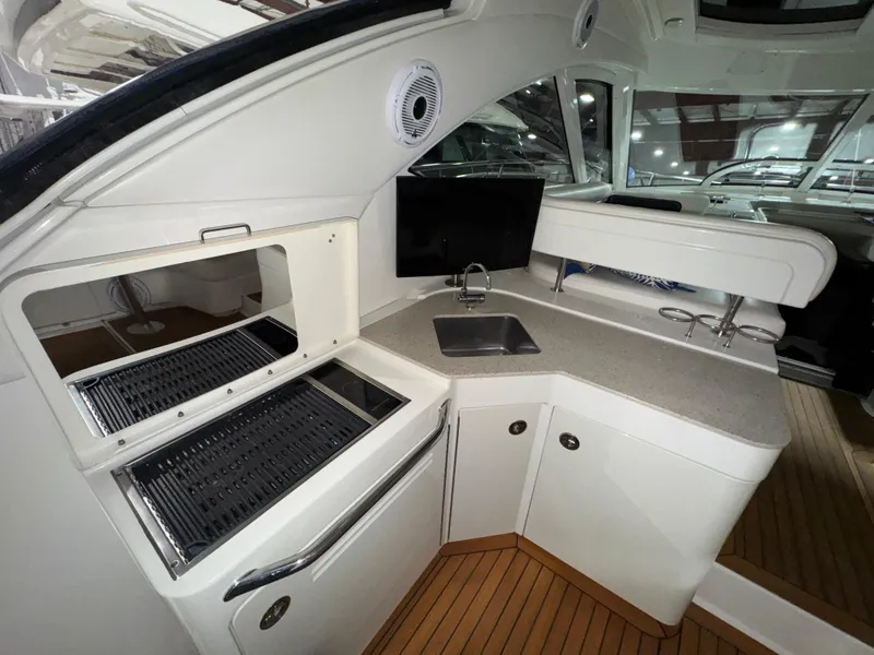 Slide: The Image of 2011 Sea Ray 470 Sundancer yacht interior with kitchenette and grill. - 43