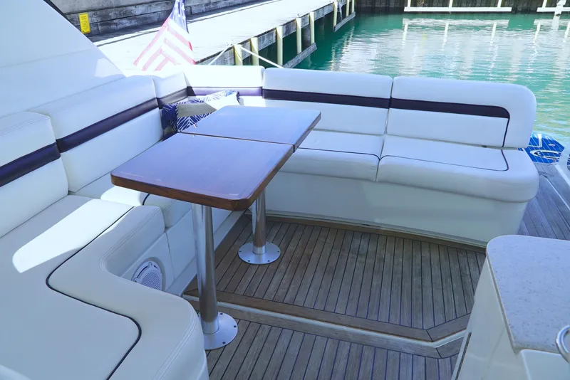 Slide: The Image of 2011 Sea Ray 470 Sundancer yacht with elegant seating and wooden deck. - 45