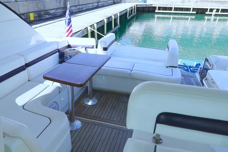 Slide: The Image of Luxurious 2011 Sea Ray 470 Sundancer yacht with elegant seating and wooden table. - 48
