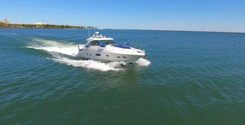 Slide: The Image of 2011 Sea Ray 470 Sundancer cruising on open water under clear skies. - 7