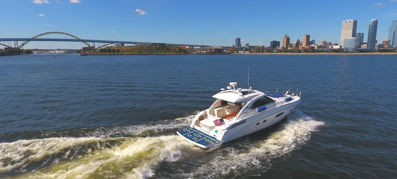 Slide: The Image of 2011 Sea Ray 470 Sundancer cruising on a sunny day near a city skyline and bridge. - 8