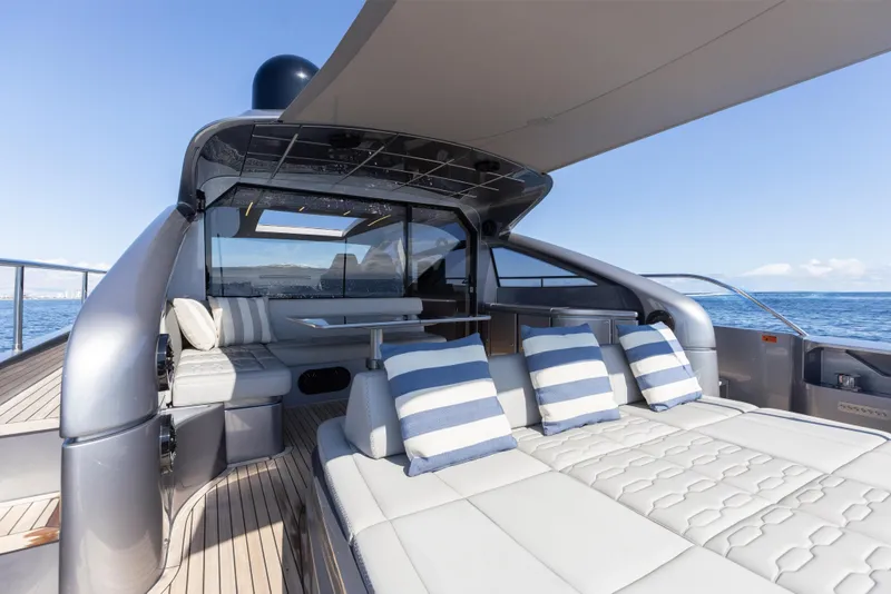Slide: The Image of Luxurious 2016 Pershing 62 yacht deck with striped cushions and ocean view. - 14