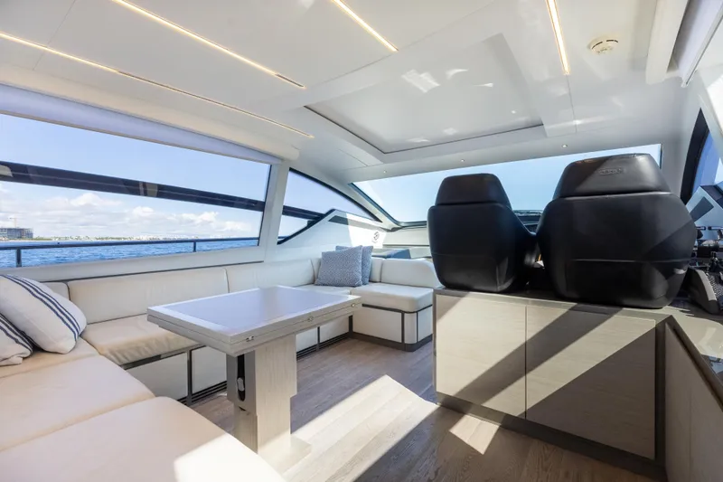 Slide: The Image of Luxurious interior of 2016 Pershing 62 yacht with modern seating and panoramic windows. - 17