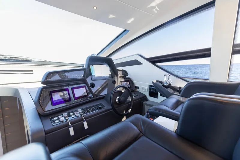 Slide: The Image of Luxurious 2016 Pershing 62 yacht cockpit with advanced navigation systems and leather seating. - 18