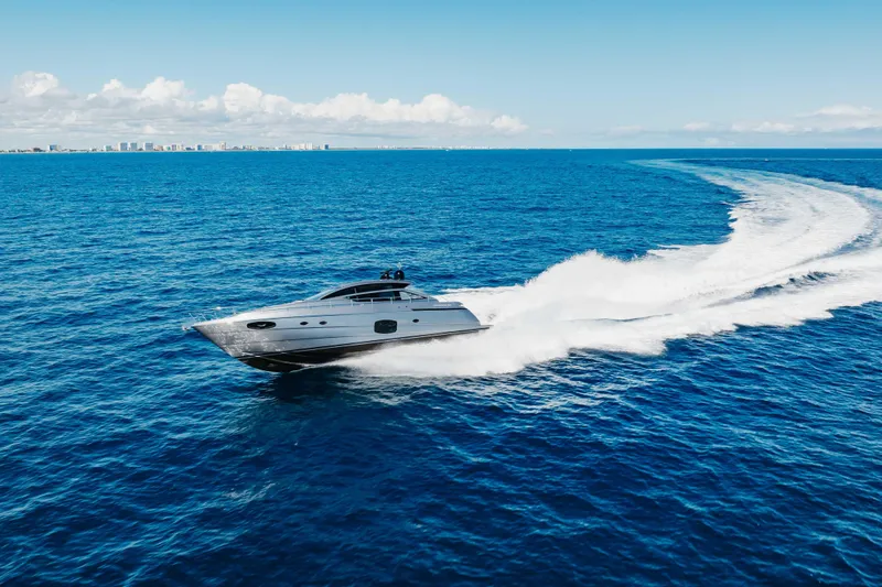 Slide: The Image of 2016 Pershing 62 yacht cruising on open blue ocean under clear sky. - 2