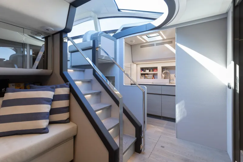 Slide: The Image of Luxurious interior of 2016 Pershing 62 yacht with modern kitchen and stylish staircase. - 22