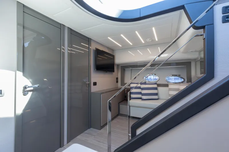 Slide: The Image of Luxurious interior of 2016 Pershing 62 yacht with modern design and striped cushions. - 23