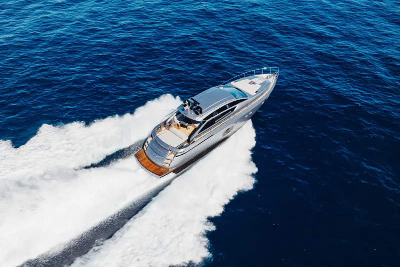 Slide: The Image of 2016 Pershing 62 yacht cruising on open blue sea, aerial view. - 3