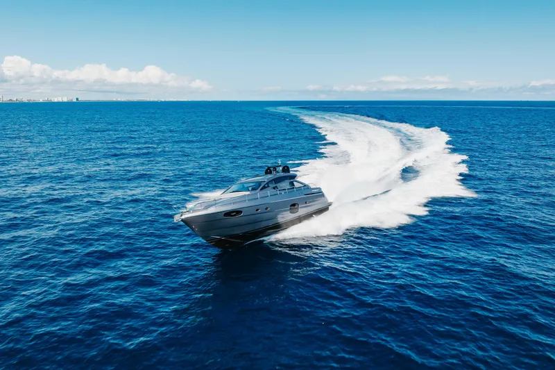 Slide: The Image of 2016 Pershing 62 yacht cruising on open blue ocean under clear sky. - 6