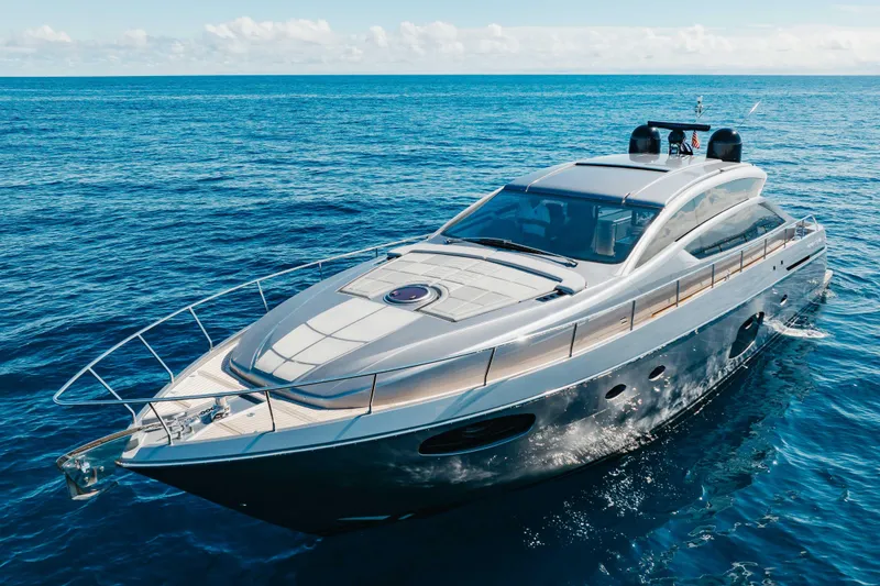 Slide: The Image of 2016 Pershing 62 yacht cruising on open blue ocean waters. - 7