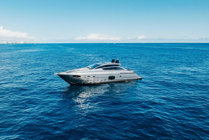 Slide: The Image of 2016 Pershing 62 yacht cruising on open blue ocean under clear sky. - 9