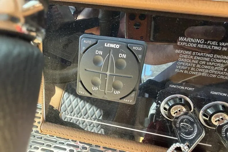 Slide: The Image of Control panel in a 2025 Cobalt R35 boat with Lenco trim tab switches. - 15