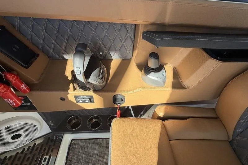 Slide: The Image of Interior of 2025 Cobalt R35 boat with tan leather and modern controls. - 16