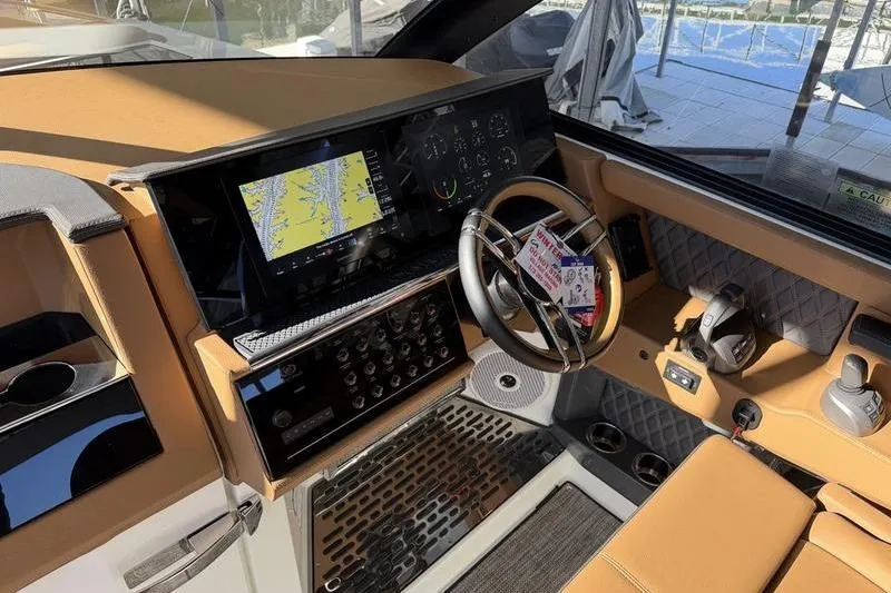 Slide: The Image of 2025 Cobalt R35 boat dashboard with navigation screen and modern controls. - 21