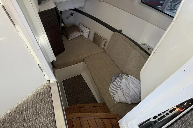 Slide: The Image of Interior cabin of 2025 Cobalt R35 boat with beige seating and cushions. - 23