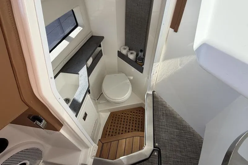 Slide: The Image of Luxurious bathroom in 2025 Cobalt R35 boat with modern amenities and wooden accents. - 26
