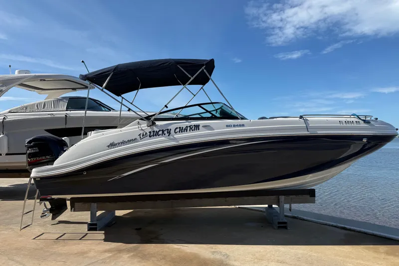 The Image of 2018 Hurricane SunDeck 2486 OB boat on display by the water. - 0
