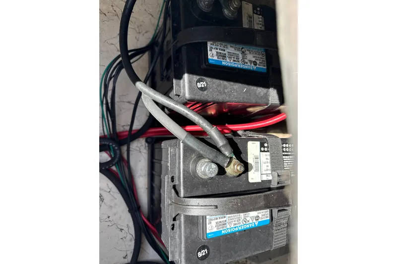 Slide: The Image of Battery compartment of 2018 Hurricane SunDeck 2486 OB with connected cables. - 16