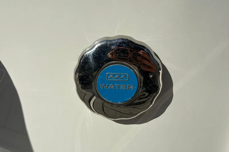 Slide: The Image of Water cap on 2018 Hurricane SunDeck 2486 OB boat, metallic with blue center. - 18