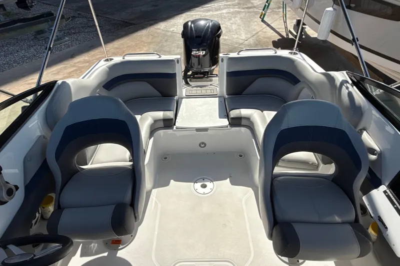 Slide: The Image of 2018 Hurricane SunDeck 2486 OB boat interior with seating and outboard motor. - 23