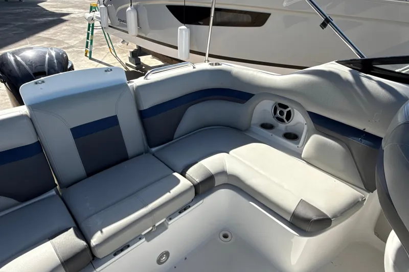 Slide: The Image of 2018 Hurricane SunDeck 2486 OB boat interior with cushioned seating and cup holders. - 26