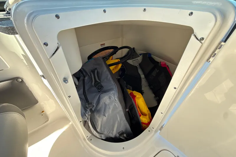 Slide: The Image of Storage compartment on 2018 Hurricane SunDeck 2486 OB with life jackets and gear. - 37
