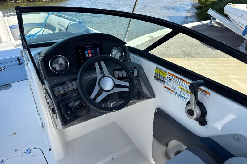 Slide: The Image of 2018 Hurricane SunDeck 2486 OB boat cockpit with steering wheel and control panel. - 40