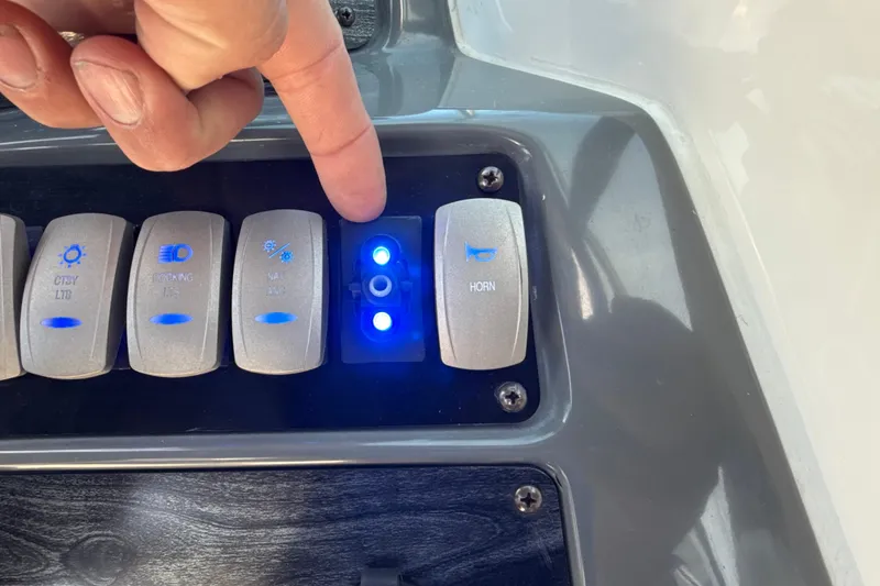 Slide: The Image of Control panel of 2018 Hurricane SunDeck 2486 OB boat with illuminated switches. - 47