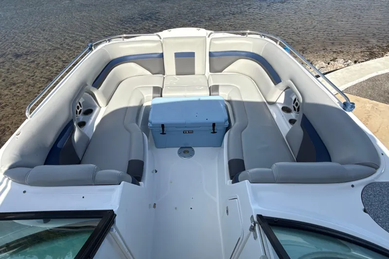 Slide: The Image of 2018 Hurricane SunDeck 2486 OB boat interior with spacious seating and cooler. - 51