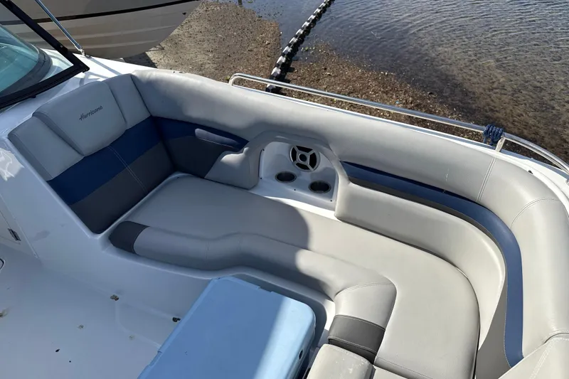 Slide: The Image of 2018 Hurricane SunDeck 2486 OB boat interior with cushioned seating and cup holders. - 52