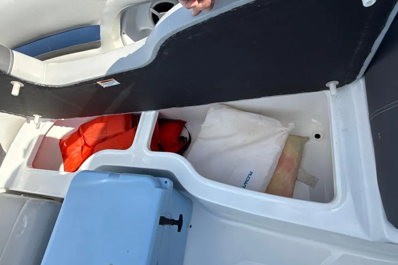 Slide: The Image of 2018 Hurricane SunDeck 2486 OB boat storage with life jackets and gear. - 56