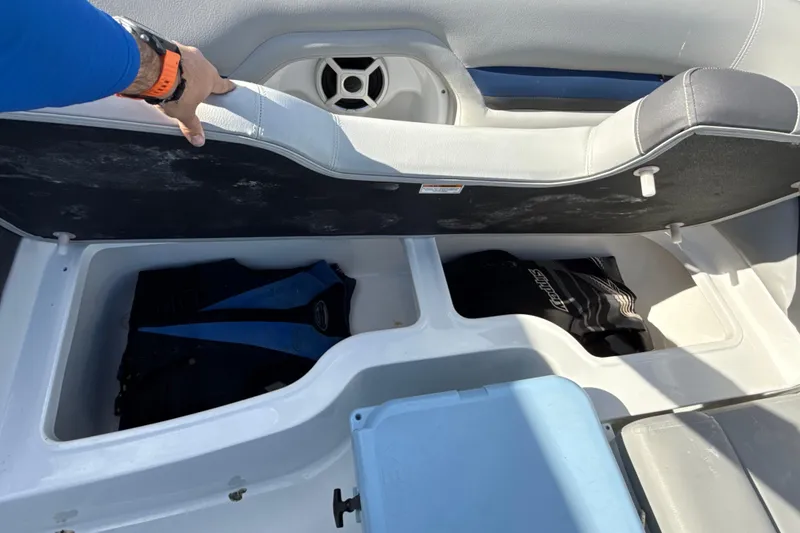 Slide: The Image of 2018 Hurricane SunDeck 2486 OB boat storage compartment with life jackets and cooler. - 57