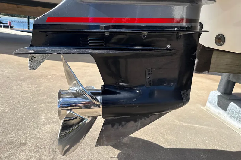 Slide: The Image of 2018 Hurricane SunDeck 2486 OB outboard motor with shiny propeller on display. - 9