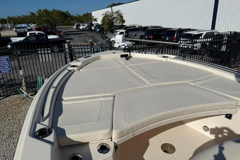 Slide: The Image of 2024 Grady-White 231 Coastal Explorer boat deck with cushioned seating and fishing rod holders. - 13