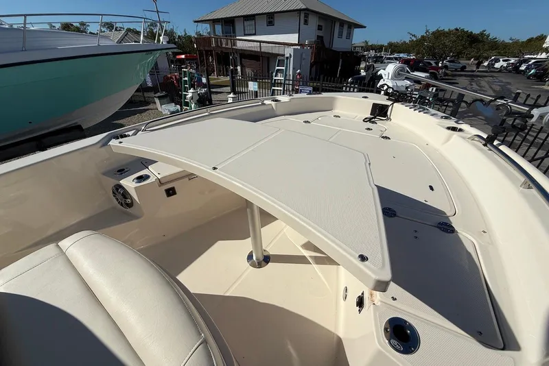 Slide: The Image of 2024 Grady-White 231 Coastal Explorer boat interior with seating and deck features. - 16