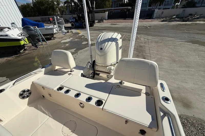 Slide: The Image of 2024 Grady-White 231 Coastal Explorer boat interior with Yamaha engine, docked outdoors. - 17