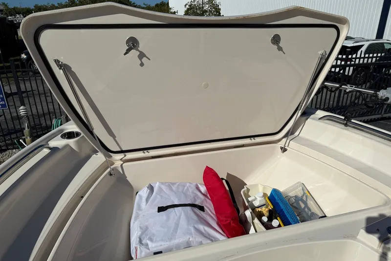 Slide: The Image of Open storage compartment on 2024 Grady-White 231 Coastal Explorer boat, showing various items. - 20