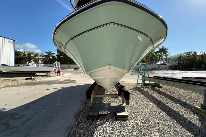 Slide: The Image of 2024 Grady-White 231 Coastal Explorer boat on dry dock under clear blue sky. - 4