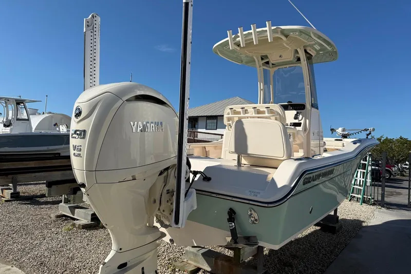 Slide: The Image of 2024 Grady-White 231 Coastal Explorer boat with Yamaha engine, docked outdoors. - 5