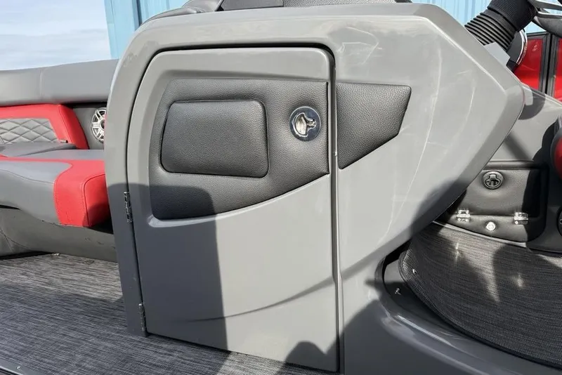 Slide: The Image of Hand opening storage compartment on 2026 Godfrey Monaco 235 SFL boat. - 10