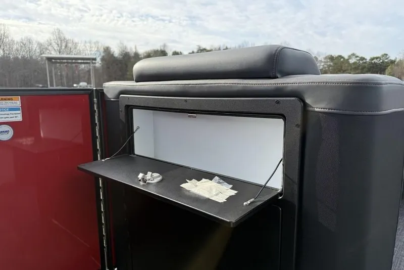 Slide: The Image of 2026 Godfrey Monaco 235 SFL boat seating with red and gray upholstery, diamond stitching, and speaker. - 11