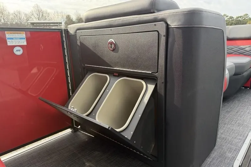 Slide: The Image of Storage compartment on 2026 Godfrey Monaco 235 SFL boat, featuring sleek black and red design. - 13