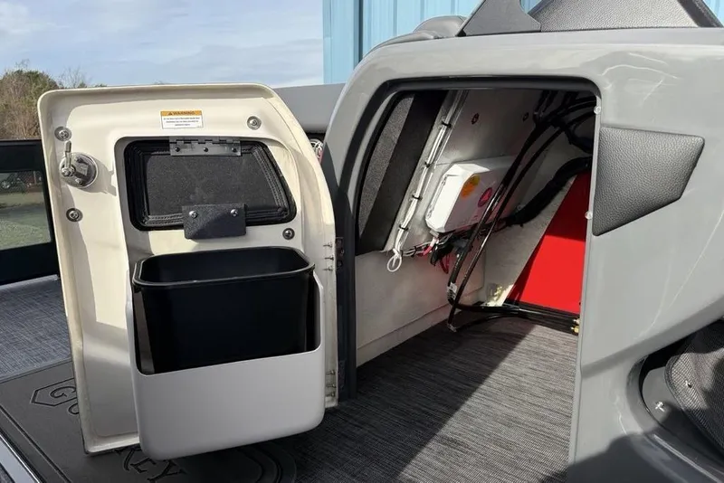 Slide: The Image of 2026 Godfrey Monaco 235 SFL storage compartment with open lid, showcasing interior space. - 14