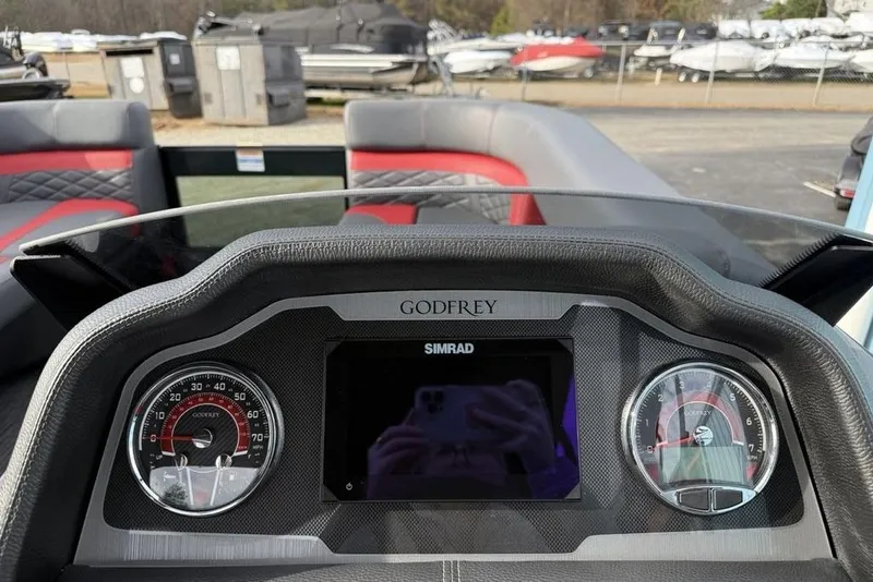 Slide: The Image of 2026 Godfrey Monaco 235 SFL boat interior with storage compartments and seating. - 15