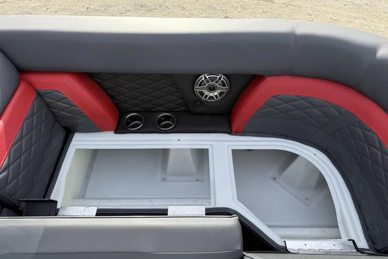 Slide: The Image of 2026 Godfrey Monaco 235 SFL boat interior with red and gray seating, cup holders, and speaker. - 6