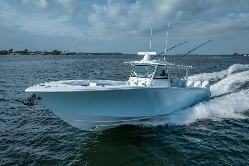Slide: The Image of 2026 Yellowfin 42 Offshore boat cruising on open water under a cloudy sky. - 11