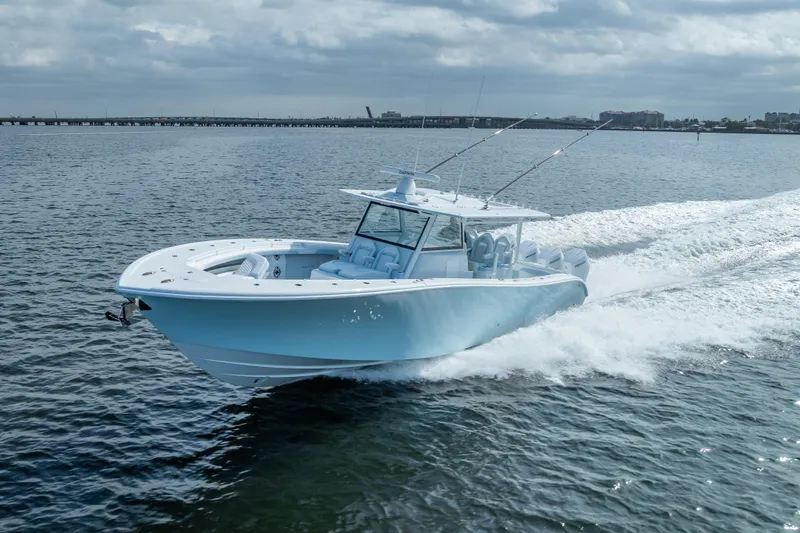 Slide: The Image of 2026 Yellowfin 42 Offshore boat cruising on open water under cloudy skies. - 12