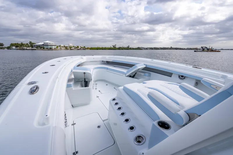 Slide: The Image of 2026 Yellowfin 42 Offshore boat with spacious deck, docked on a calm waterway. - 20