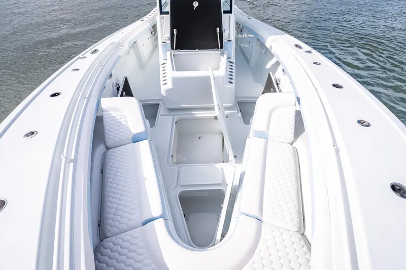 Slide: The Image of 2026 Yellowfin 42 Offshore boat interior with white seating and storage compartments. - 25